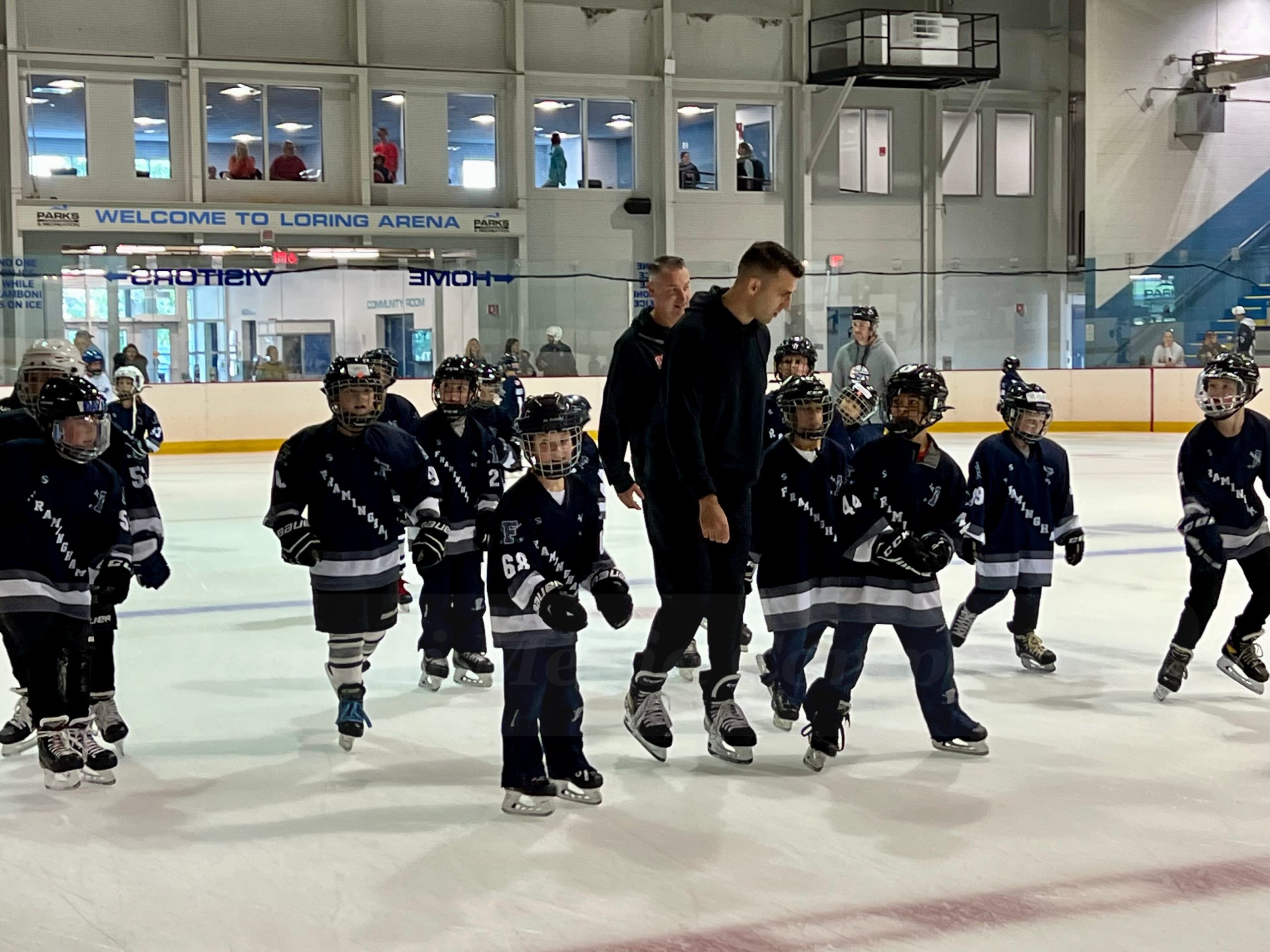 Bruins captain Patrice Bergeron skates with youth players at Loring Arena