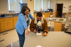 Framingham State Professor Aline Davis works with a student in a Biology Lab.